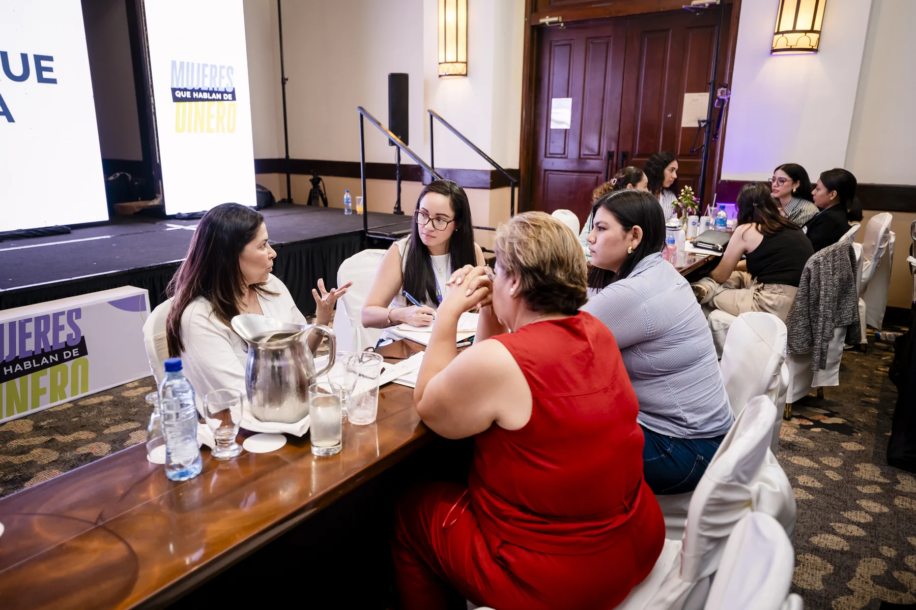 A group of women gathered around a table at the launch in Managua