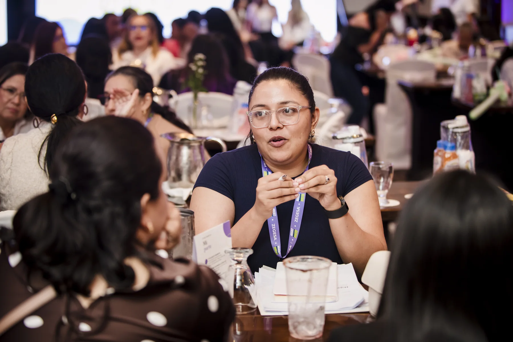 A woman shares while her group listens at the launch in Managua