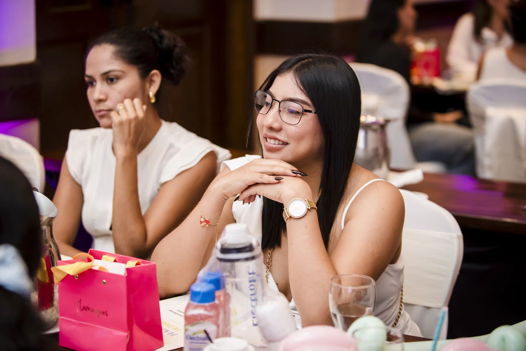 Two women listening during a conversation at the launch in Managua